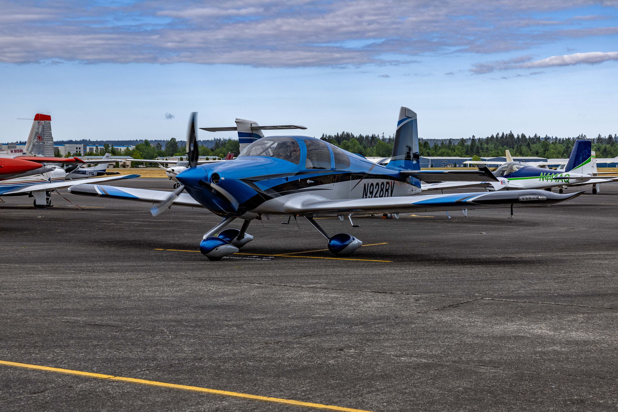 blue and white airplane on pavement
